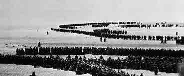 Escaping soldiers lined up on the beach at Dunkirk.
