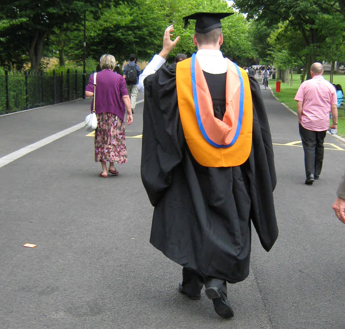 Graduation day a graduate walking down the street. Church leadership problems - choosing authentic leaders