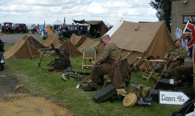 Ramsey 1940's weekend with British soldiers relaxing by there tents and weapons.