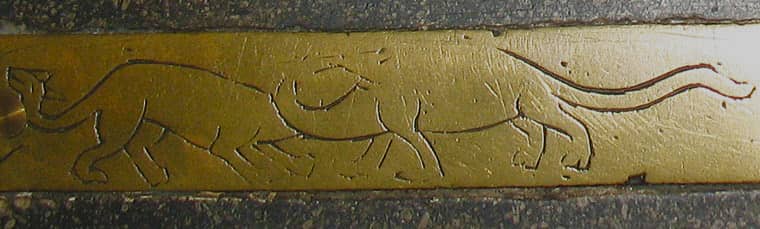 A medieval brass showing two dinosaurs or dragons at Carlisle Cathedral.