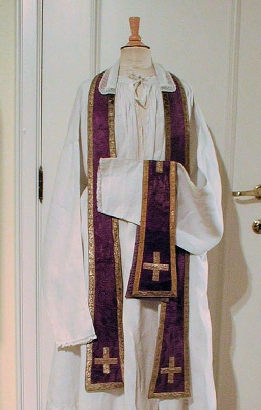 A stole around the neck and a chasuble on the arm. Should a Minister of Religion wear a uniform?