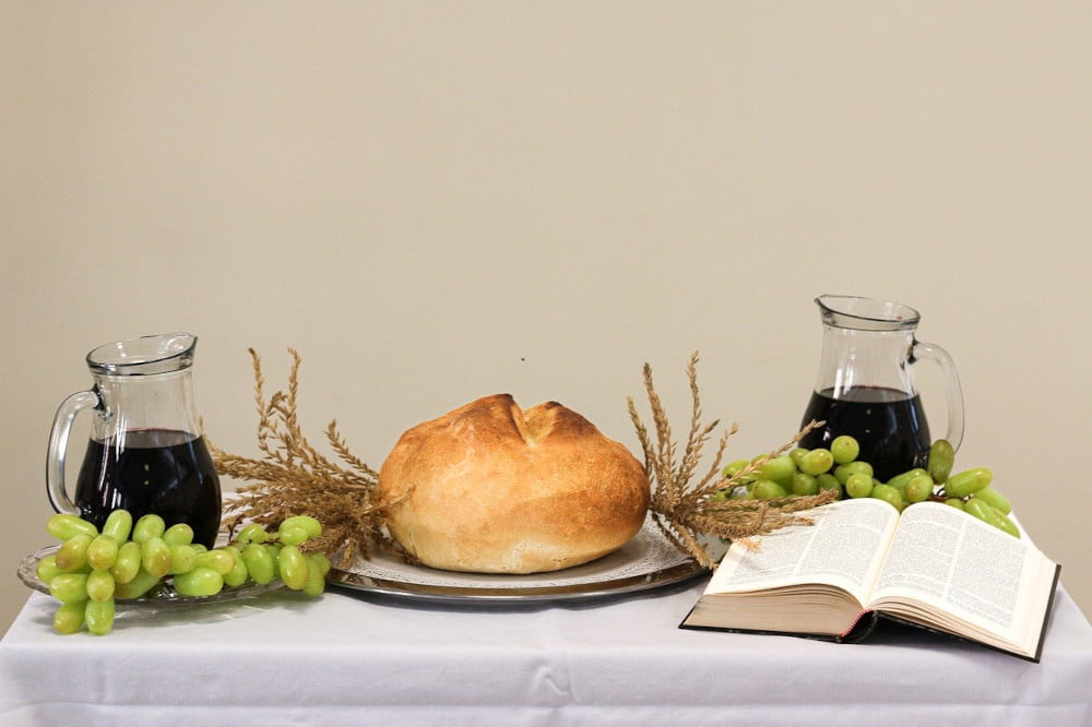 Bread and wine with grapes on a table. What is the Last Supper lesson plan.
