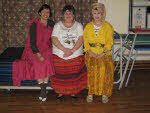 Three ladies from the human village in flowing dresses.