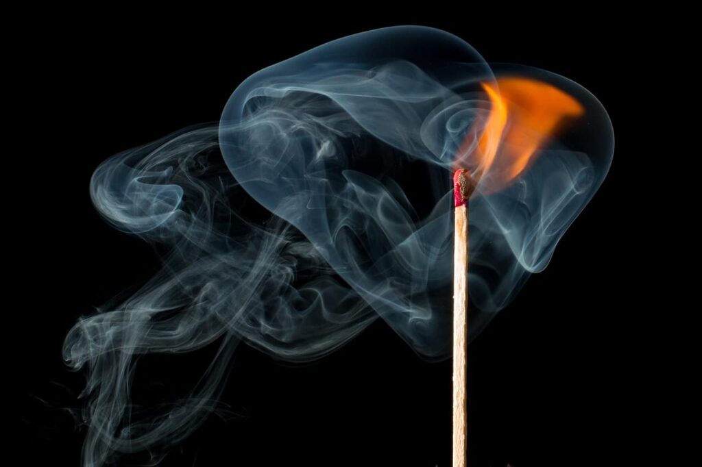 A lighted match with smoke. Tanganyikan safari: Fire in the night.